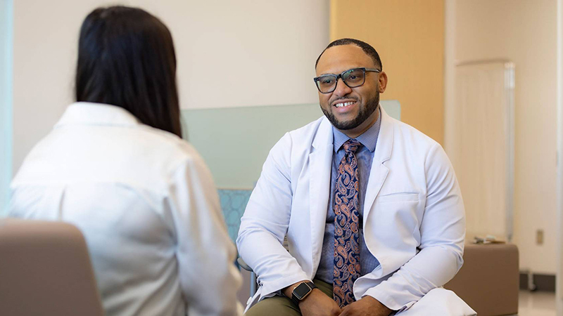 Chris Hall speaking with a patient