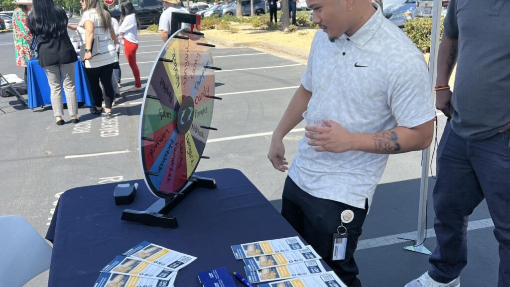Man spins wheel with various prizes