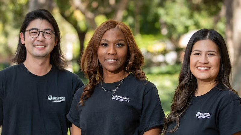 Smiling people in UC Riverside-branded T-shirts