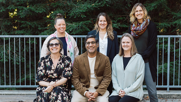 Six people posing for group photo