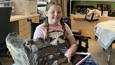 Young girl meeting an alligator