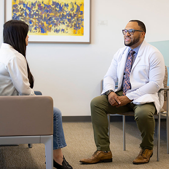 Chris Hall speaks with a colleague
