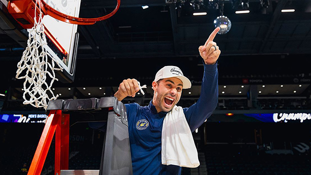 Clint Allard hanging from a basketball hoop