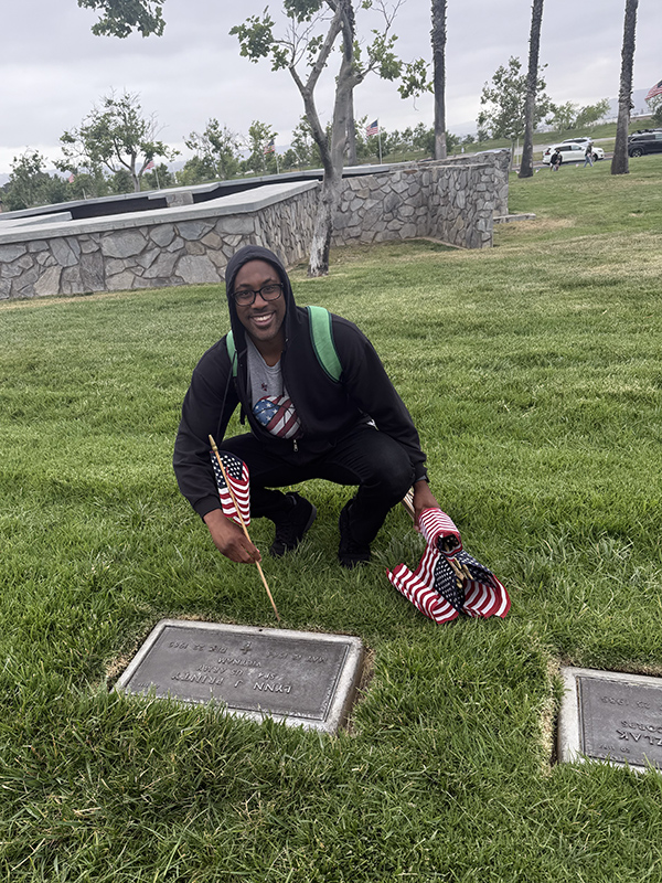 Man placing flag on grave