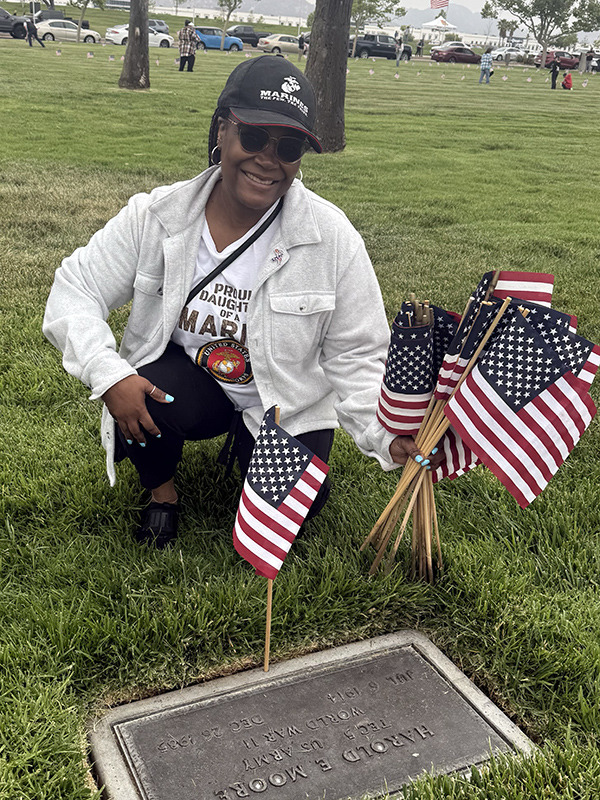 Woman placing flag on grave