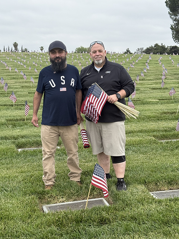 Two men holding American flags
