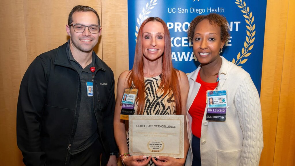 Group of smiling people holding a certificate