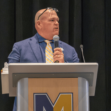 David Dunham standing at a podium