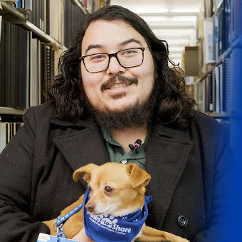 Gomez Manzo holding a tiny dog
