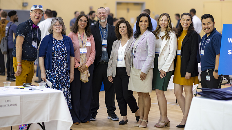 Group of people standing together in business attire