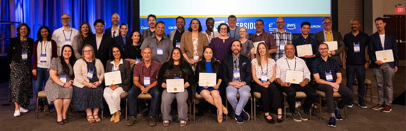 Group of people holding award certificates