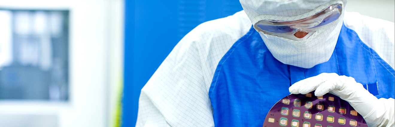 Person in protective gear holding scientific device