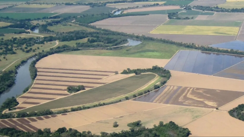 Drone photo of river and surrounding farmland