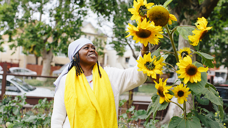 Woman looking at sunflowers