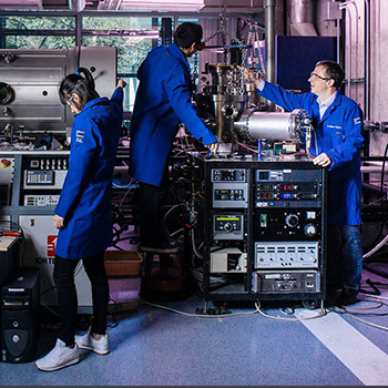 Group of people working on tech in a lab