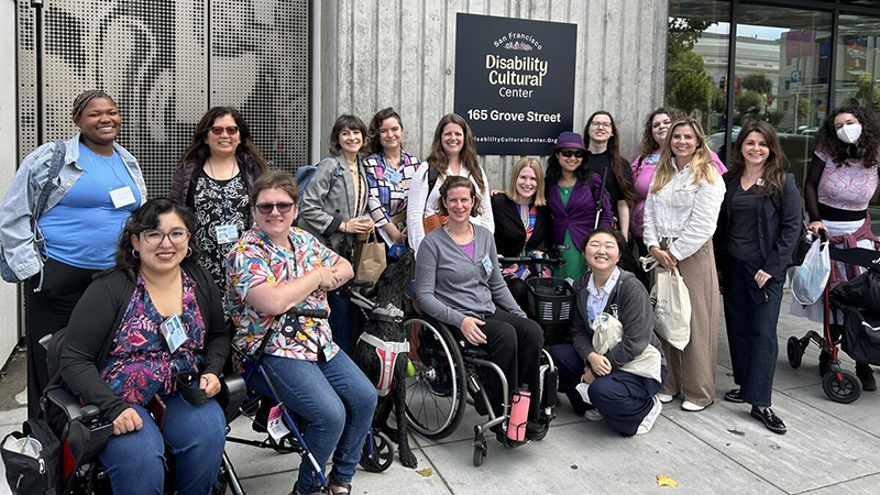 Group of happy people, some standing and some in wheelchairs