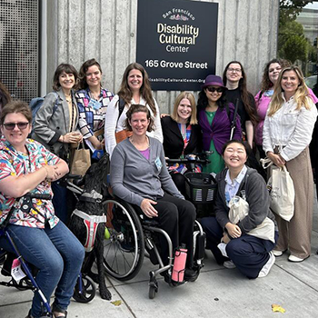 Group of happy people, some standing and some in wheelchairs