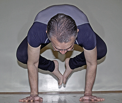 Arturo doing crow pose
