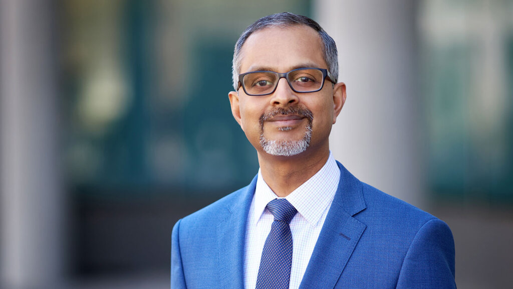 Suresh Gunasekaran wearing a blue suit and tie
