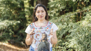 Woman holding a printed photograph embellished with embroidery