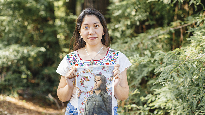 Woman holding a printed photograph embellished with embroidery