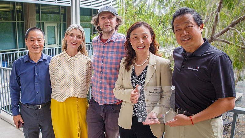 Smiling people holding an award
