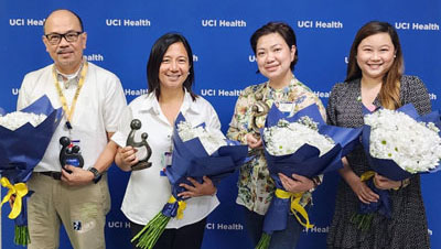 Daisy Award recipients holding flowers