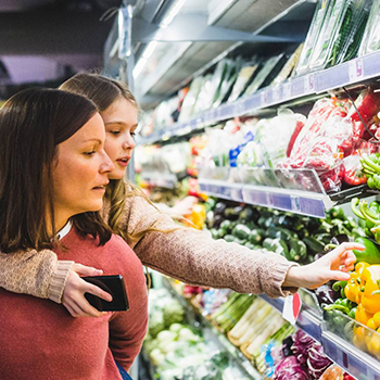 Mother and daughter grocery shopping