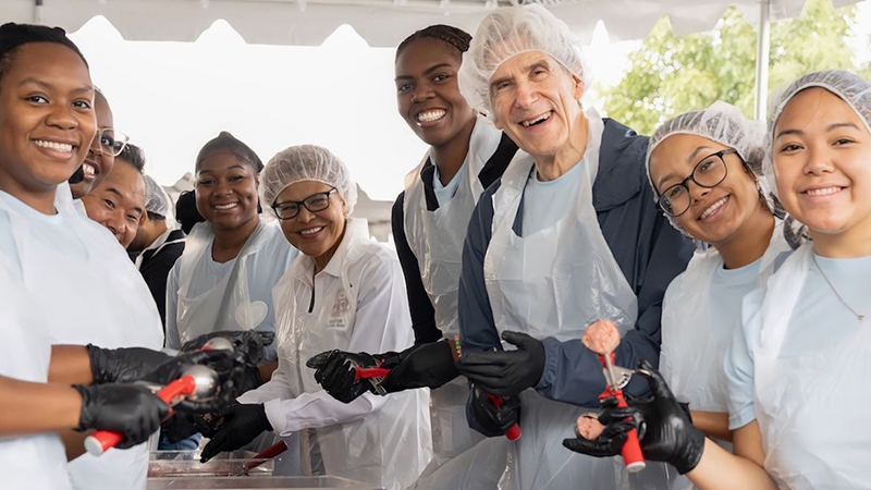 People making hamburgers in an assembly line