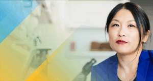 Slightly smiling person in a blue suit.