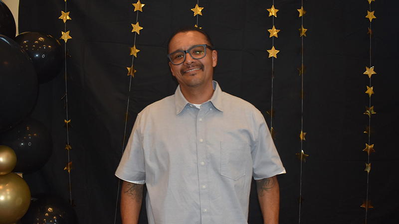 Sammy Chavez in front of a star-decorated wall
