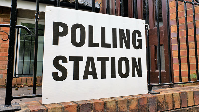Building with a banner that says "polling station"