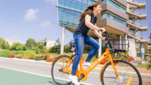 Student driving electric bicycle at UCSD