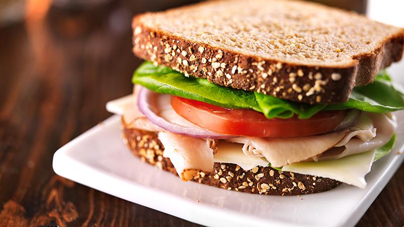 cold cut turkey sandwich on whole wheat with swiss cheese