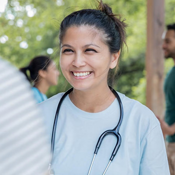 Smiling doctor talking to a patient outdoors