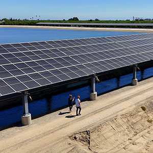 People walking alongside a solar canal