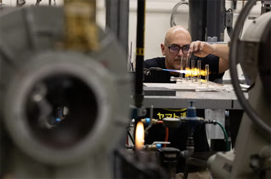 Stephen using equipment in his shop