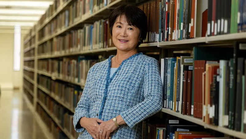 Mihoko standing in the library stacks