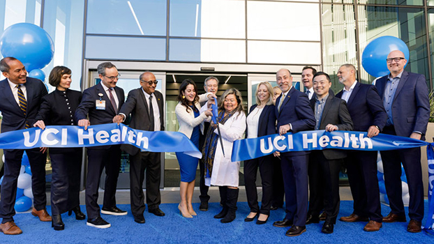 People in suits cutting a ceremonial giant ribbon