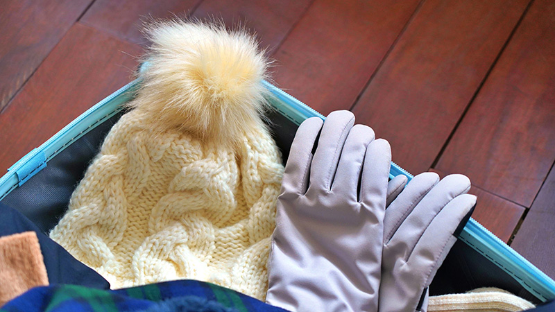 Suitcase filled with winter clothing