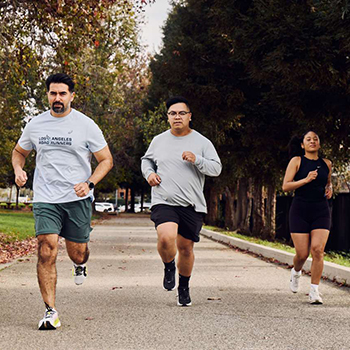 Three people running on the UCLA campus