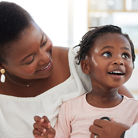 Pediatrics doctor with stethoscope, mother and child in consultation office. Happy mom and toddler kid in clinic exam checkup or appointment with healthcare worker listening for heart and baby health.