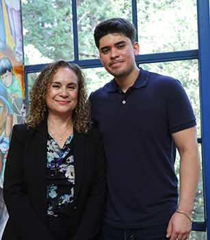 Maria and Ruben standing by a window at UC Santa Cruz