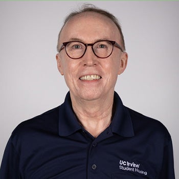 Lou Gill standing in a hallway