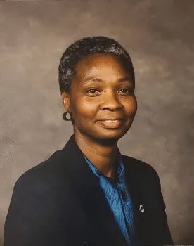 Archival photo of Mary wearing a suit.