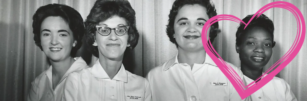 Four women looking proudly at the camera in nursing uniforms