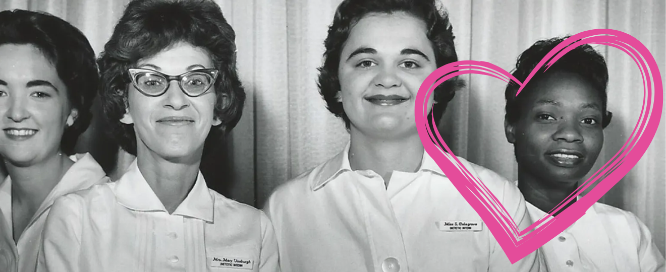 Four women looking proudly at the camera in nursing uniforms