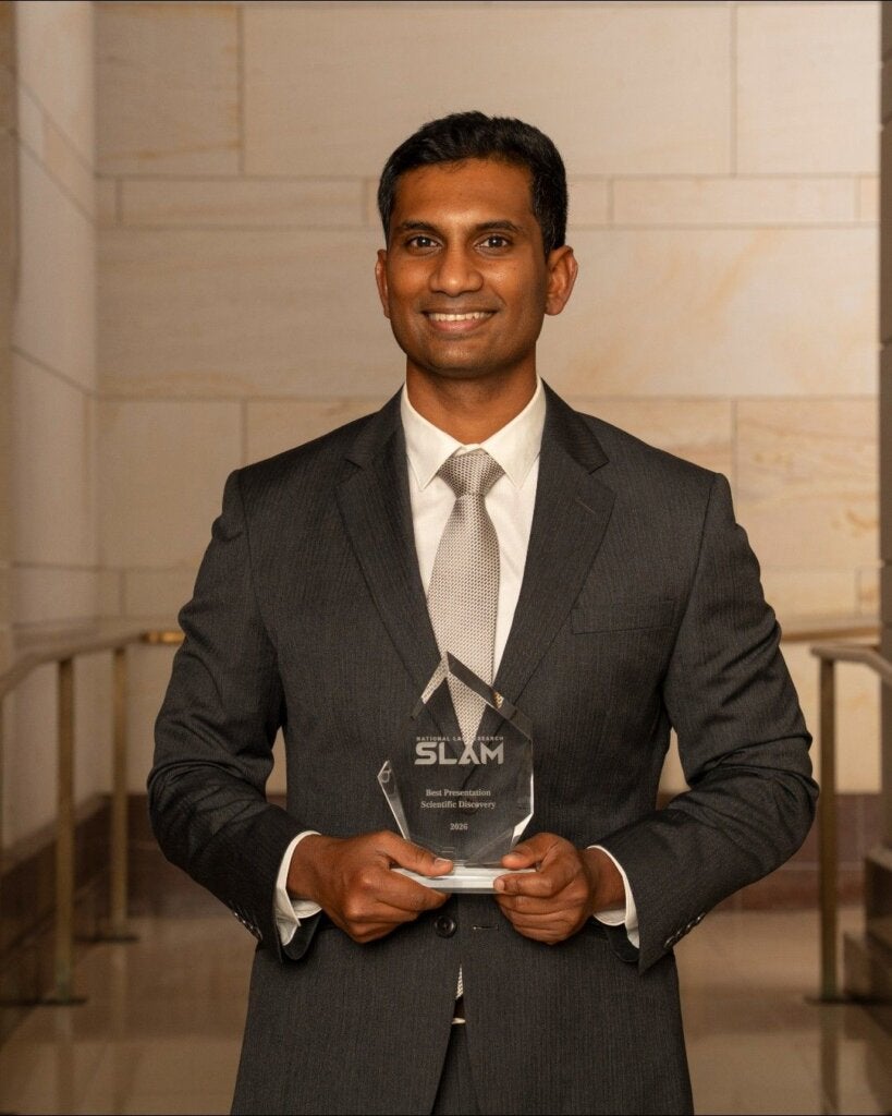 Yash holding glass trophy