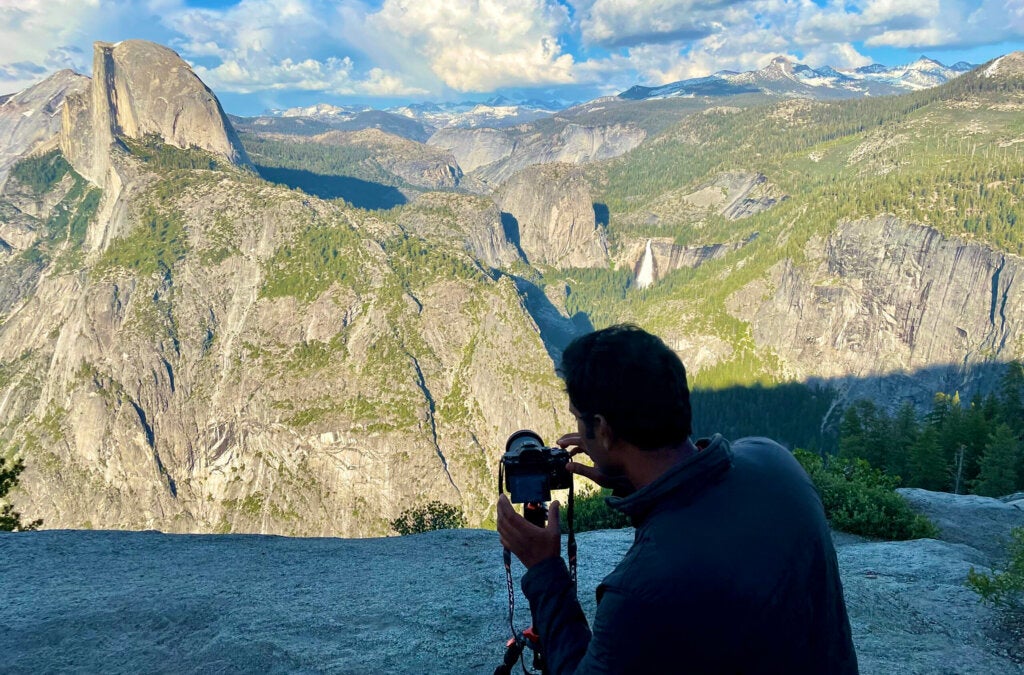 Man setting up tripod behind El Capitan