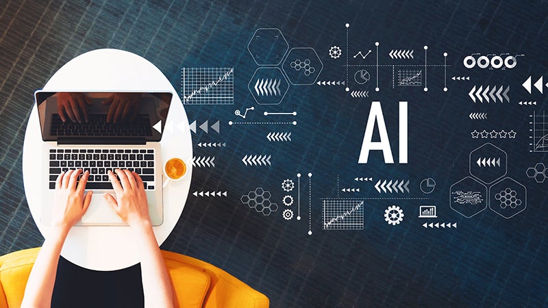 AI with person using a laptop on a white table